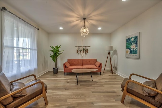 2606 Smart Ave, Kansas City, MO 64124 - living area featuring light wood finished floors, recessed lighting, and a chandelier