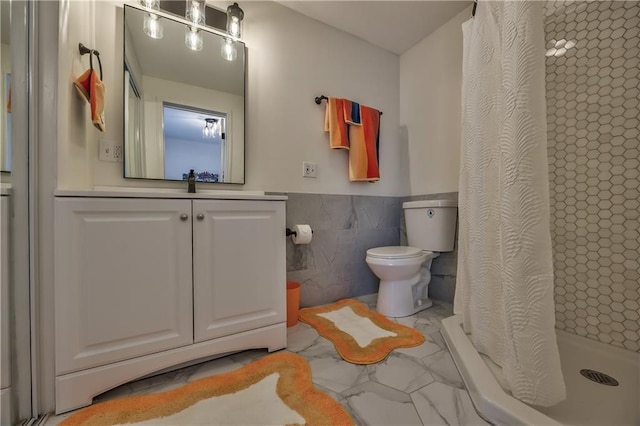 2606 Smart Ave, Kansas City, MO 64124 - bathroom with tile walls, marble finish floors, vanity, a shower with curtain, and a wainscoted wall