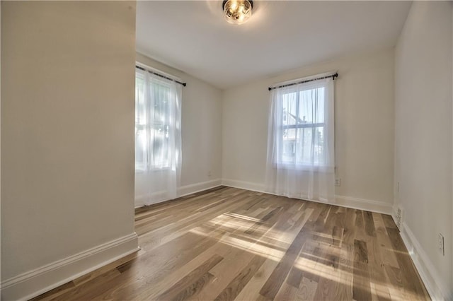 2606 Smart Ave, Kansas City, MO 64124 - empty room featuring wood finished floors and baseboards