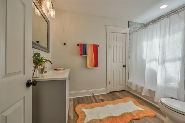 2606 Smart Ave, Kansas City, MO 64124 - bathroom with vanity and wood finished floors