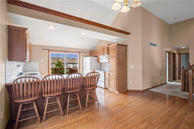 913 N Cochise Ave, Independence, MO 64056 - dining room featuring light wood-style flooring and vaulted ceiling