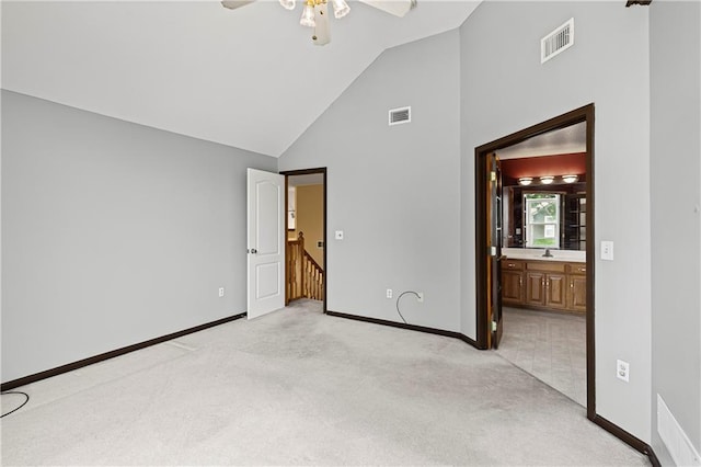 913 N Cochise Ave, Independence, MO 64056 - unfurnished bedroom with light carpet, high vaulted ceiling, ensuite bathroom, and ceiling fan