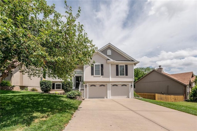 207 Woodhaven Dr, Smithville, MO 64089 - view of front facade with an attached garage and driveway