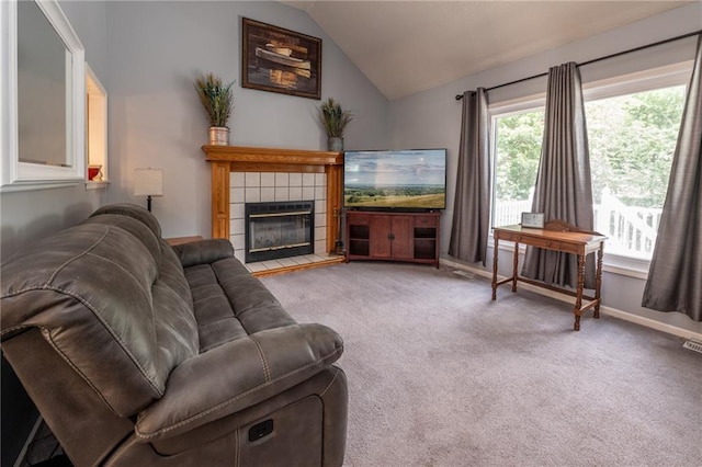 207 Woodhaven Dr, Smithville, MO 64089 - living room featuring lofted ceiling, carpet floors, and a tile fireplace