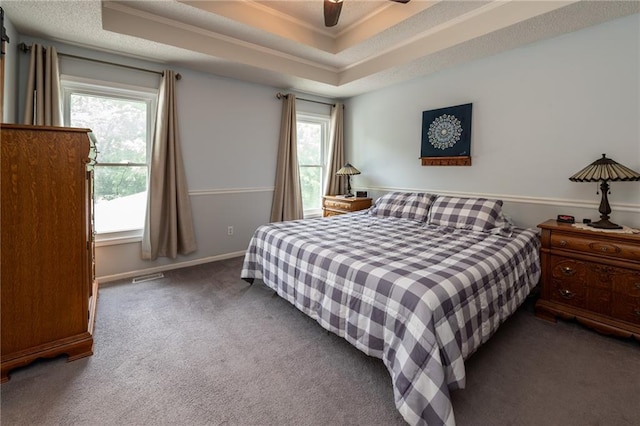 207 Woodhaven Dr, Smithville, MO 64089 - carpeted bedroom featuring multiple windows, a ceiling fan, crown molding, and a raised ceiling