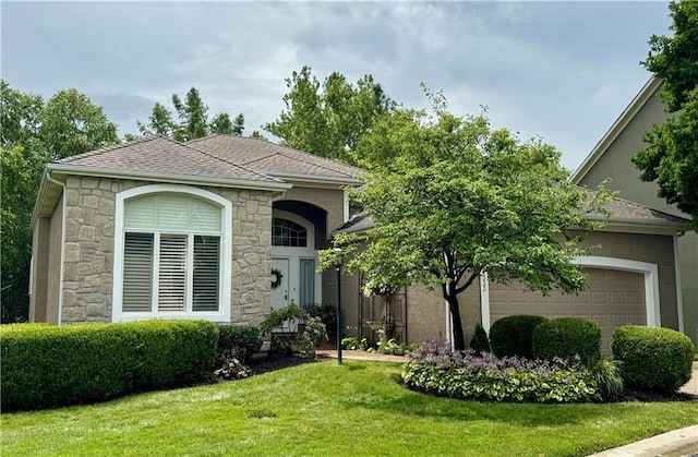 14333 Norwood St, Leawood, KS 66224 - view of front of house featuring stone siding, a front lawn, stucco siding, roof with shingles, and a garage