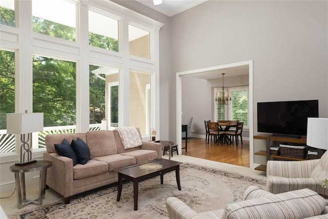 14333 Norwood St, Leawood, KS 66224 - living room with wood finished floors, a chandelier, and a towering ceiling