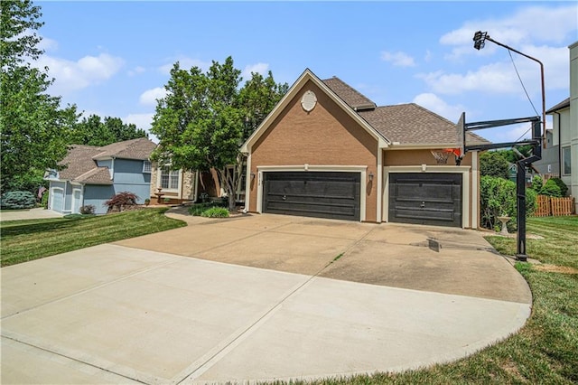 5713 NE Sapphire Ct, Lees Summit, MO 64064 - view of front of house featuring a front yard, an attached garage, driveway, and stucco siding