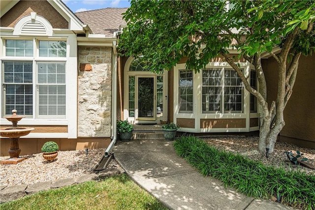 5713 NE Sapphire Ct, Lees Summit, MO 64064 - doorway to property featuring stone siding and a shingled roof