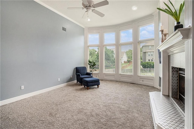 5713 NE Sapphire Ct, Lees Summit, MO 64064 - unfurnished room with ornamental molding, ceiling fan, a fireplace with raised hearth, and carpet flooring