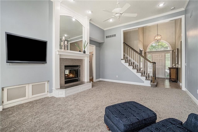 5713 NE Sapphire Ct, Lees Summit, MO 64064 - living area with carpet floors, ornamental molding, stairs, a fireplace, and recessed lighting