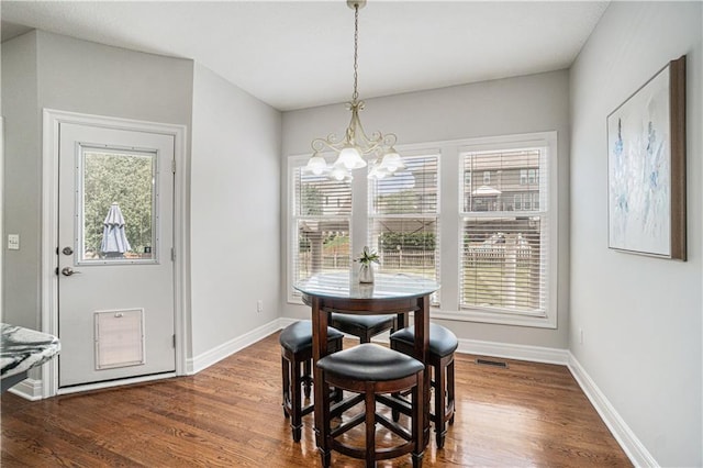 5713 NE Sapphire Ct, Lees Summit, MO 64064 - dining space with a chandelier and wood finished floors