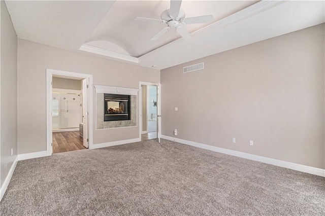 5713 NE Sapphire Ct, Lees Summit, MO 64064 - unfurnished bedroom featuring carpet flooring, a raised ceiling, connected bathroom, ceiling fan, and a multi sided fireplace