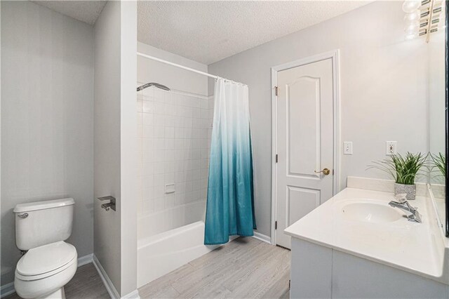 5713 NE Sapphire Ct, Lees Summit, MO 64064 - full bath featuring wood finished floors, vanity, shower / bathtub combination with curtain, and a textured ceiling