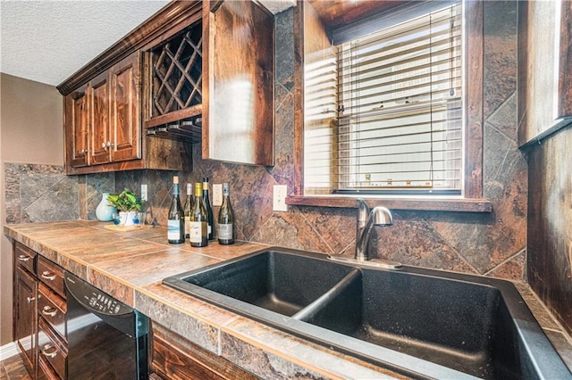 5713 NE Sapphire Ct, Lees Summit, MO 64064 - kitchen featuring dishwasher, tile counters, tasteful backsplash, and a textured ceiling
