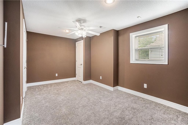 5713 NE Sapphire Ct, Lees Summit, MO 64064 - unfurnished bedroom featuring light colored carpet, a ceiling fan, and a textured ceiling