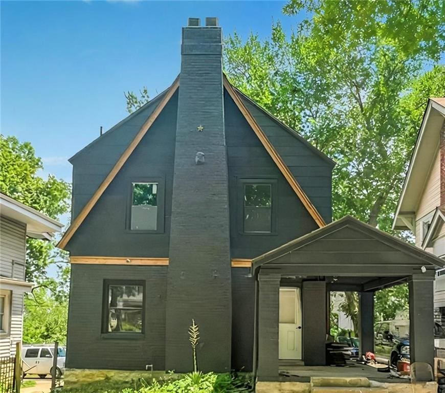 3315 Benton Blvd, Kansas City, MO 64128 - rear view of house with a chimney