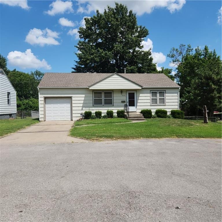 9529 Summit St, Lenexa, KS 66215 - view of front facade featuring an attached garage, driveway, and roof with shingles