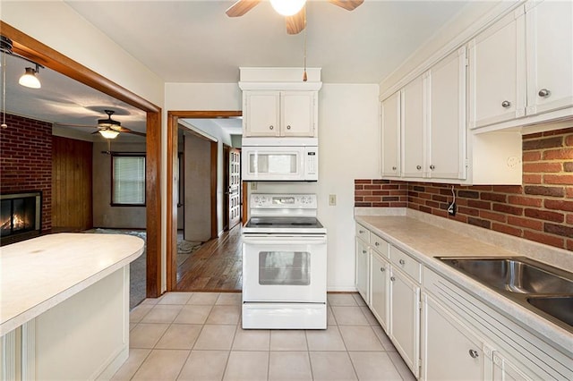 8201 W 89th St, Overland Park, KS 66212 - kitchen with white appliances, ceiling fan, white cabinets, light tile patterned flooring, and light countertops