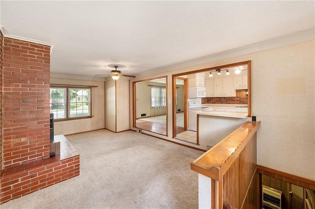 8201 W 89th St, Overland Park, KS 66212 - unfurnished living room featuring a wood stove, crown molding, light colored carpet, and ceiling fan