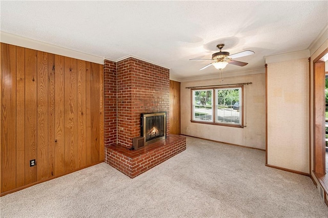 8201 W 89th St, Overland Park, KS 66212 - unfurnished living room featuring a ceiling fan, a brick fireplace, ornamental molding, carpet, and wood walls