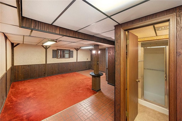 8201 W 89th St, Overland Park, KS 66212 - finished below grade area with wooden walls, wainscoting, a drop ceiling, and brick patterned floors