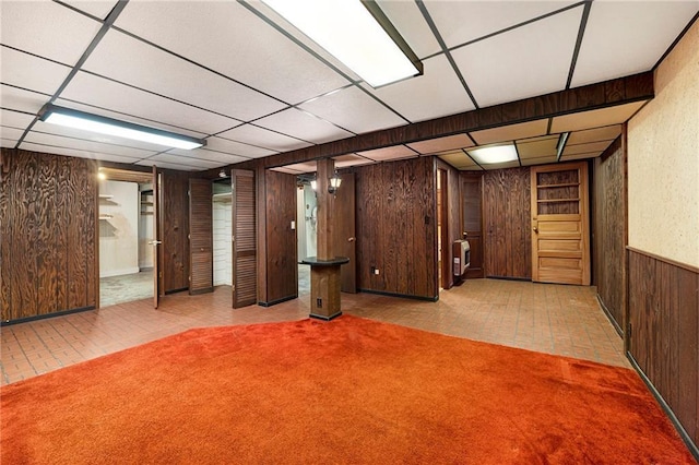 8201 W 89th St, Overland Park, KS 66212 - finished basement with wood walls, a drop ceiling, and heating unit