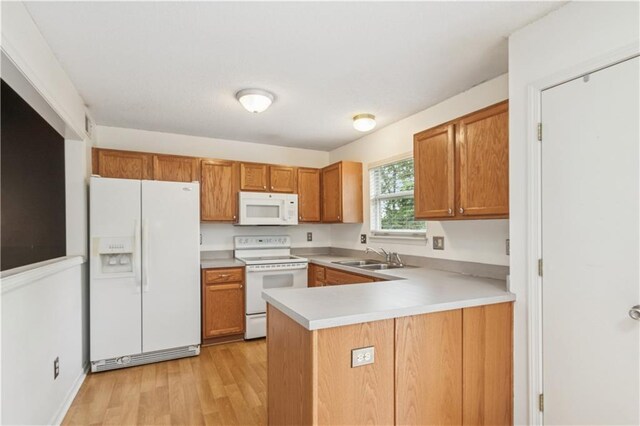 17150 S Walter St, Gardner, KS 66030 - kitchen featuring white appliances, brown cabinetry, light wood finished floors, a peninsula, and light countertops