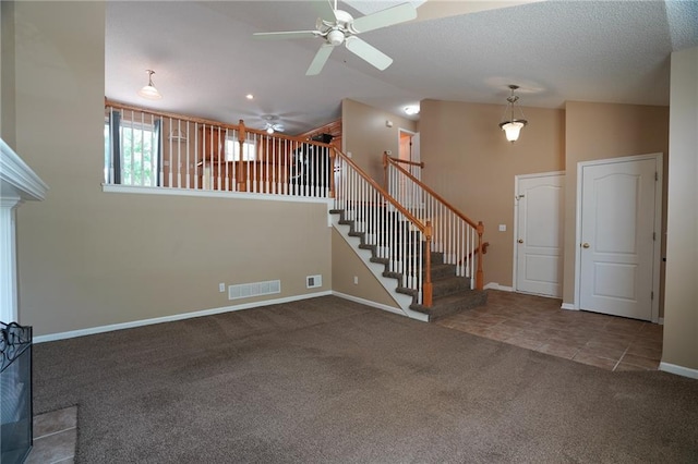 17586 W 161st St, Olathe, KS 66062 - unfurnished living room featuring a ceiling fan, carpet, stairway, vaulted ceiling, and tile patterned flooring
