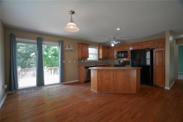 17586 W 161st St, Olathe, KS 66062 - kitchen featuring black appliances, light wood-type flooring, a ceiling fan, a center island, and decorative backsplash