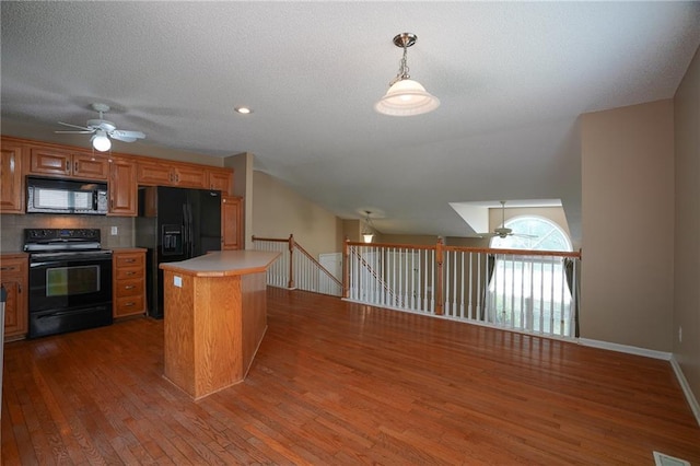 17586 W 161st St, Olathe, KS 66062 - kitchen featuring black appliances, ceiling fan, wood finished floors, light countertops, and a textured ceiling