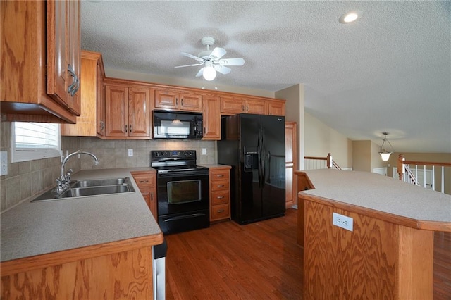 17586 W 161st St, Olathe, KS 66062 - kitchen featuring black appliances, a ceiling fan, wood finished floors, a textured ceiling, and a kitchen island