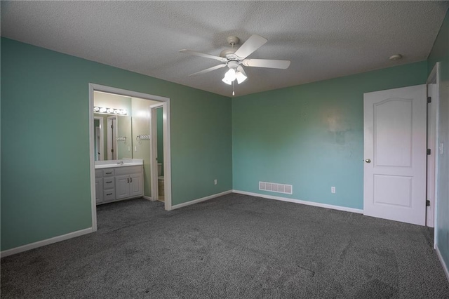 17586 W 161st St, Olathe, KS 66062 - unfurnished bedroom featuring dark carpet, a textured ceiling, connected bathroom, and a ceiling fan