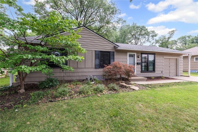 8751 Goddard St, Overland Park, KS 66214 - rear view of house with a garage, a lawn, and driveway