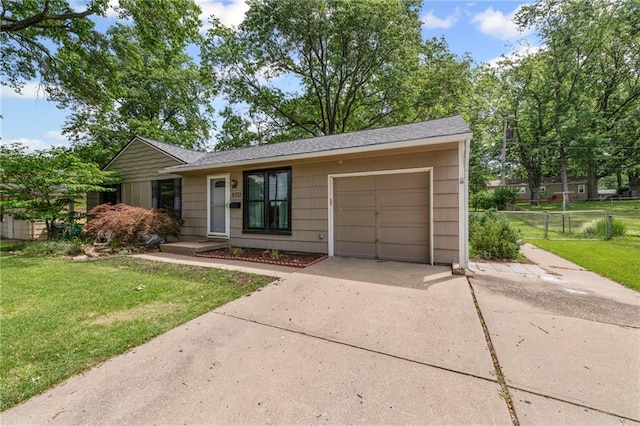 8751 Goddard St, Overland Park, KS 66214 - ranch-style house with concrete driveway, an attached garage, and a shingled roof