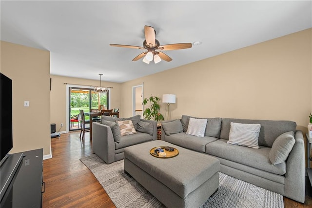 8751 Goddard St, Overland Park, KS 66214 - living area featuring wood finished floors, a ceiling fan, and a chandelier