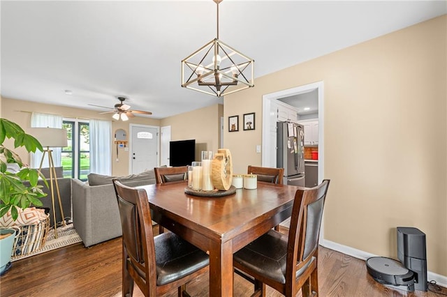 8751 Goddard St, Overland Park, KS 66214 - dining space with dark wood-type flooring, a chandelier, and a ceiling fan