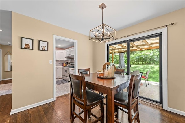 8751 Goddard St, Overland Park, KS 66214 - dining room featuring dark wood finished floors, a chandelier, and arched walkways