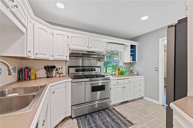 8751 Goddard St, Overland Park, KS 66214 - kitchen with double oven range, under cabinet range hood, white cabinetry, light countertops, and recessed lighting