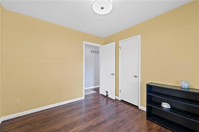 8751 Goddard St, Overland Park, KS 66214 - unfurnished bedroom with wood finished floors and baseboards