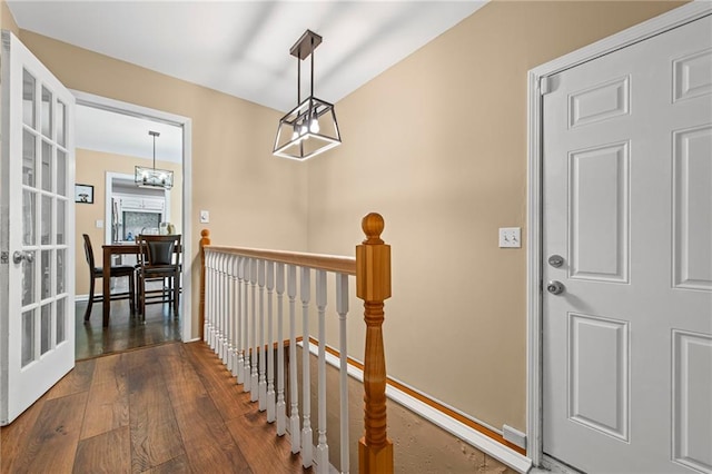 8751 Goddard St, Overland Park, KS 66214 - hall featuring an upstairs landing, a chandelier, wood-type flooring, and french doors