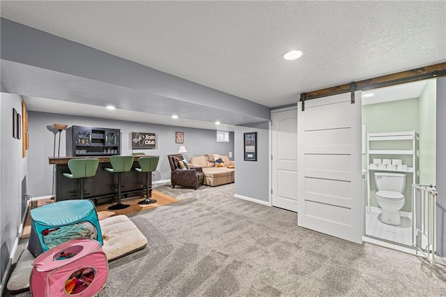 8751 Goddard St, Overland Park, KS 66214 - living room featuring carpet flooring, a textured ceiling, a barn door, and recessed lighting