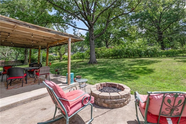 8751 Goddard St, Overland Park, KS 66214 - view of patio with a fire pit, outdoor dining area, and view of wooded area
