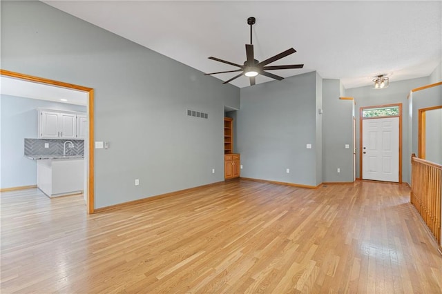 12324 S Clinton St, Olathe, KS 66061 - unfurnished living room with a ceiling fan and light wood-type flooring