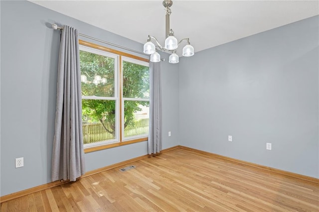 12324 S Clinton St, Olathe, KS 66061 - unfurnished room with a chandelier and light wood finished floors
