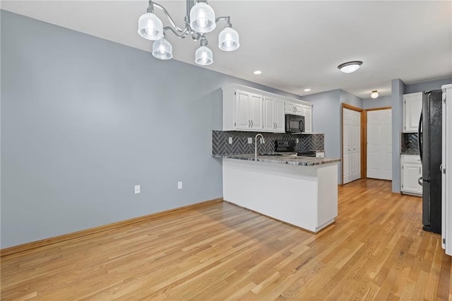 12324 S Clinton St, Olathe, KS 66061 - kitchen with black appliances, tasteful backsplash, a peninsula, white cabinets, and recessed lighting