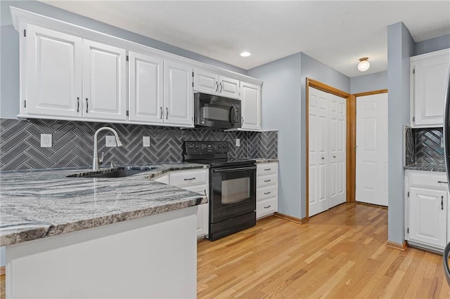 12324 S Clinton St, Olathe, KS 66061 - kitchen featuring black appliances, light wood-style floors, white cabinets, decorative backsplash, and light stone countertops