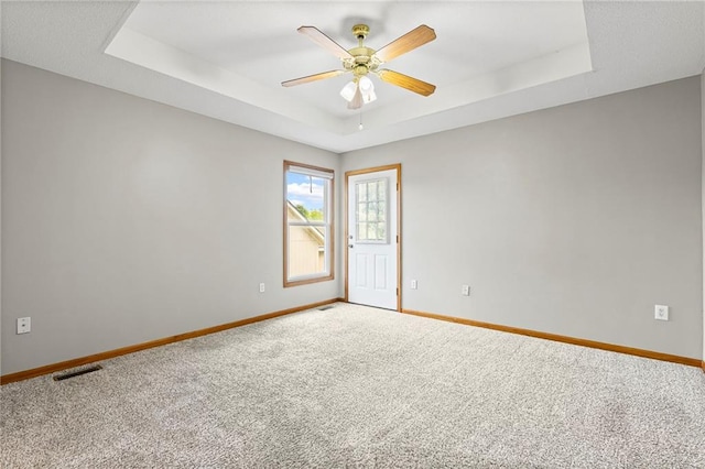 12324 S Clinton St, Olathe, KS 66061 - spare room featuring carpet floors, a raised ceiling, and ceiling fan