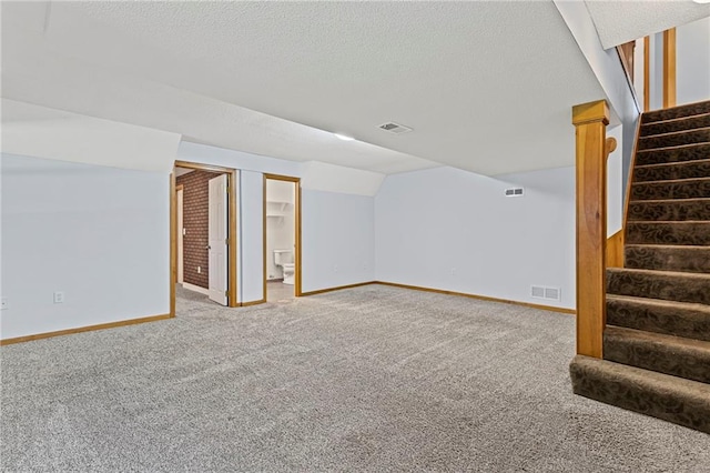 12324 S Clinton St, Olathe, KS 66061 - finished below grade area with carpet floors, stairs, and a textured ceiling
