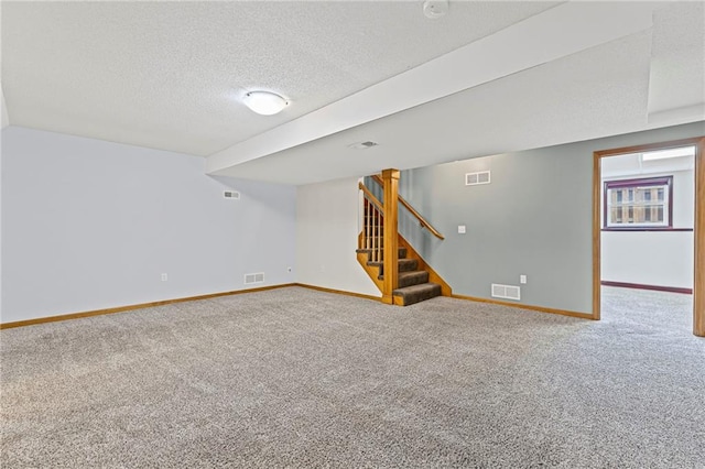 12324 S Clinton St, Olathe, KS 66061 - below grade area featuring carpet floors, a textured ceiling, and stairs